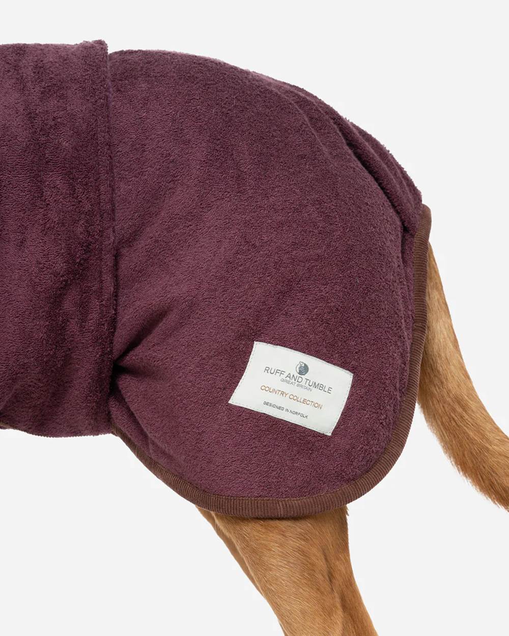 Burgundy coloured Ruff & Tumble Country Dog Drying Coat on ginger dog on white background