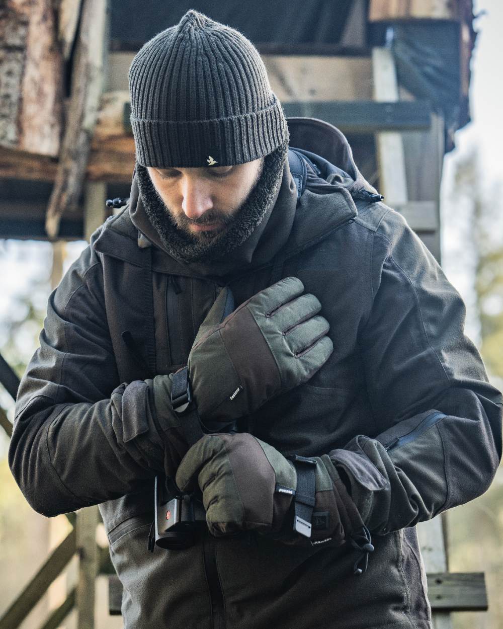 Pine Green coloured Seeland Celsius Heat Gloves on forest background
