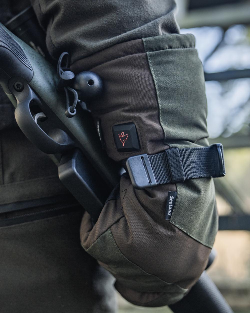 Pine Green coloured Seeland Celsius Heat Gloves on forest background