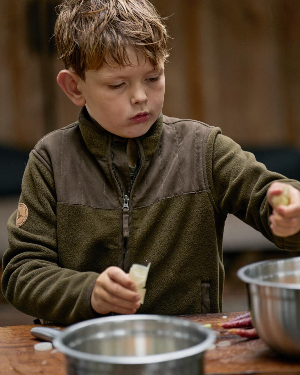 Pine Green Coloured Seeland Childrens Bolt Fleece Jacket on outdoor background