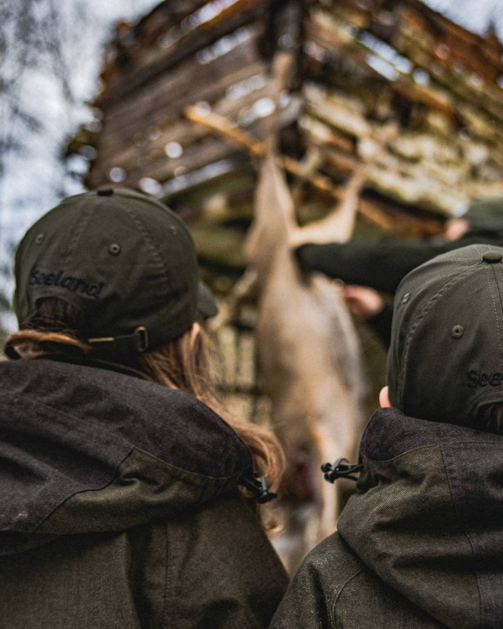 Pine Green coloured Seeland Childrens Skarn LED Junior Cap on forest background