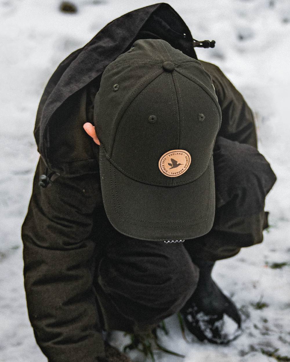 Pine Green coloured Seeland Childrens Skarn LED Junior Cap on forest background