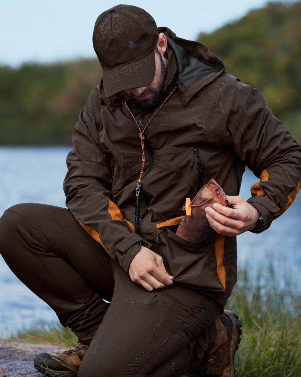 Dark Brown Coloured Seeland Dog Active Jacket On A Forest Background