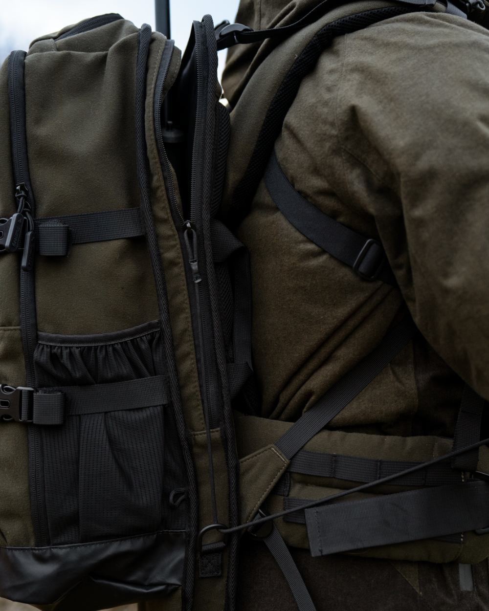 Pine Green coloured Seeland Enduro Backpack on forest background