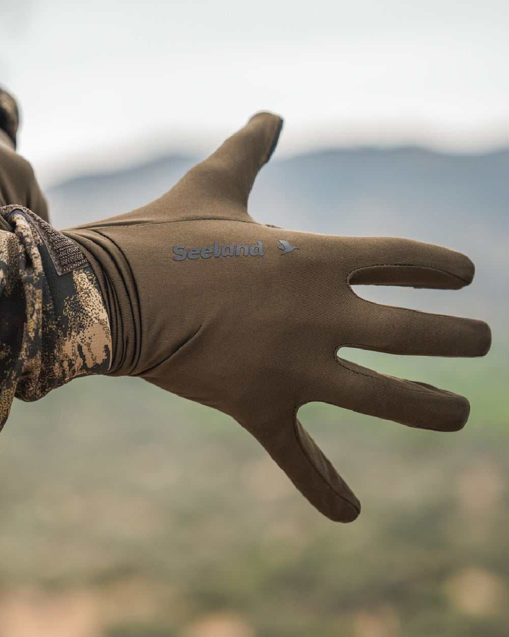 Pine Green Coloured Seeland Grip Gloves on outdoor background