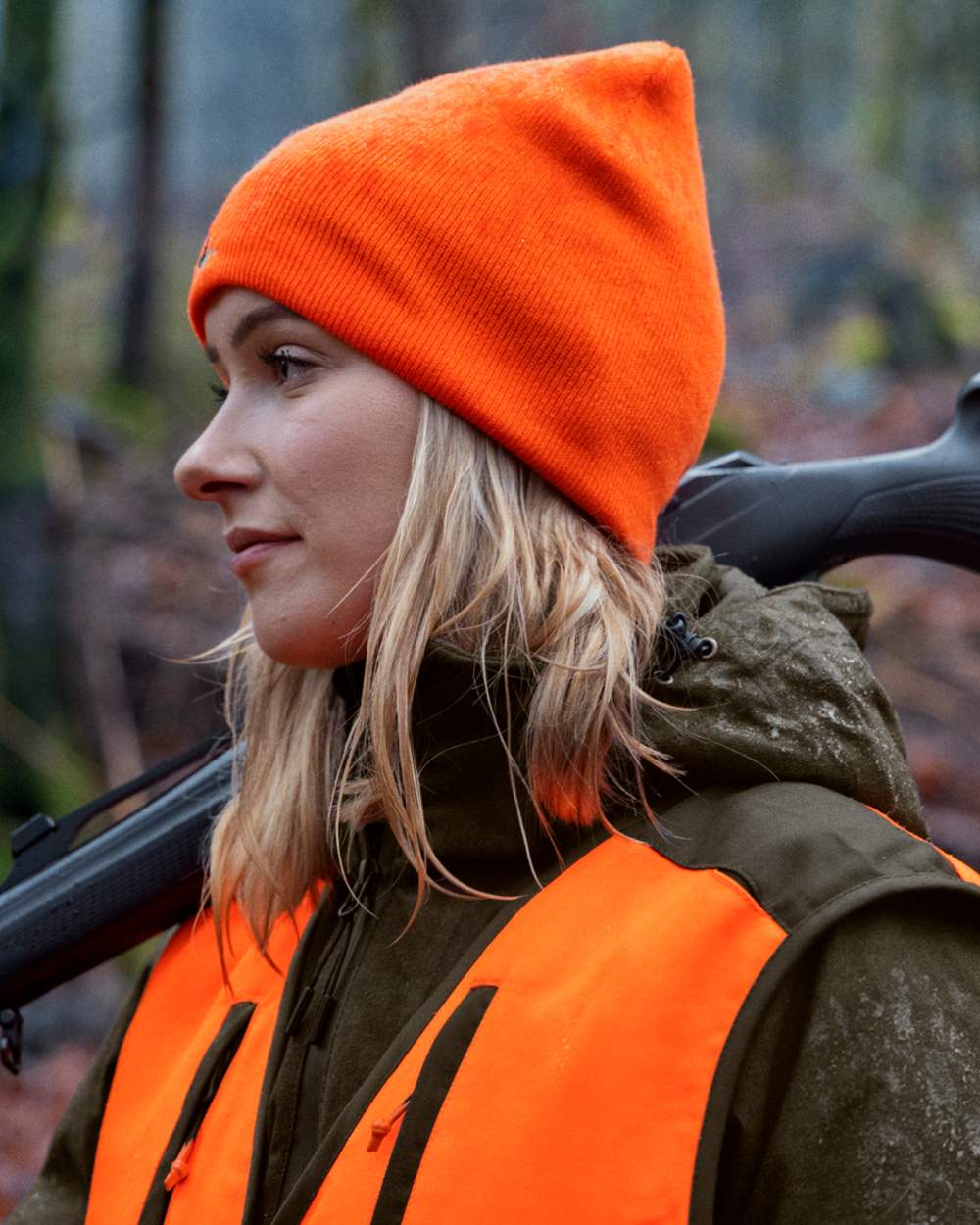 Hi-Vis Orange Pine Green Coloured Seeland Ian Reversible Beanie Hat on outdoor background