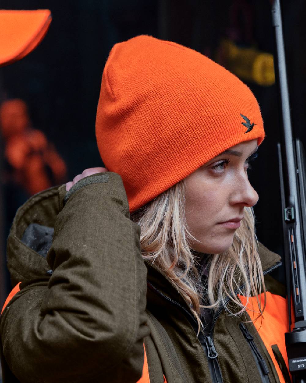 Hi-Vis Orange Pine Green Coloured Seeland Ian Reversible Beanie Hat on outdoor background
