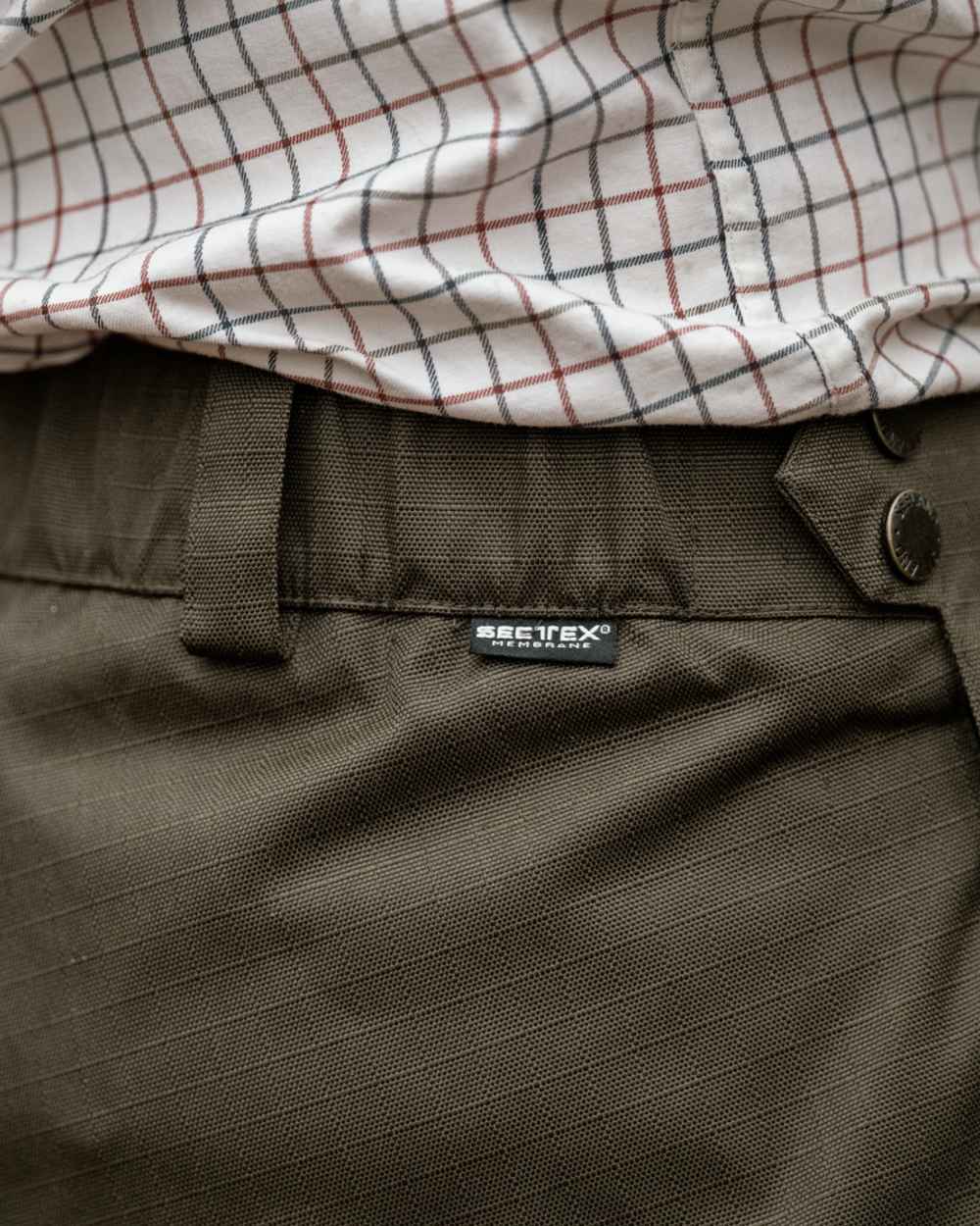 Shaded Olive coloured Seeland Mens Buckthorn Duro Overtrousers on forest background