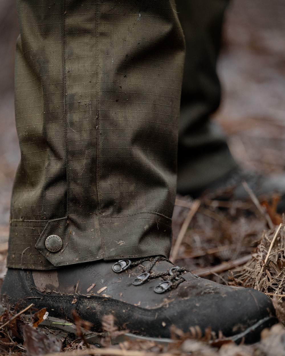 Shaded Olive coloured Seeland Mens Buckthorn Duro Overtrousers on forest background