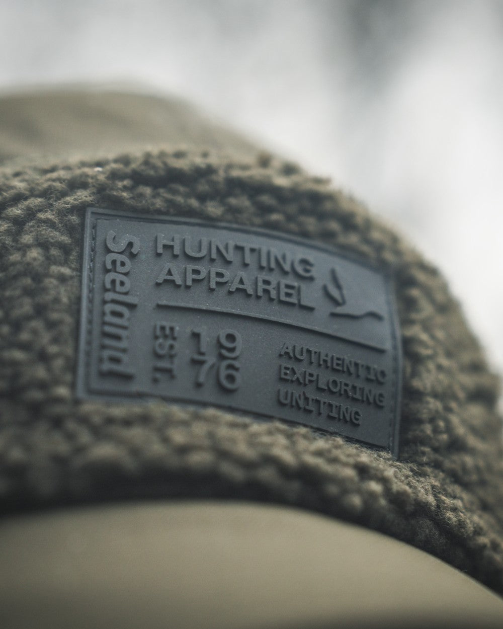 Pine Green coloured Seeland Mens Teddy Fold Down Cap on fog background