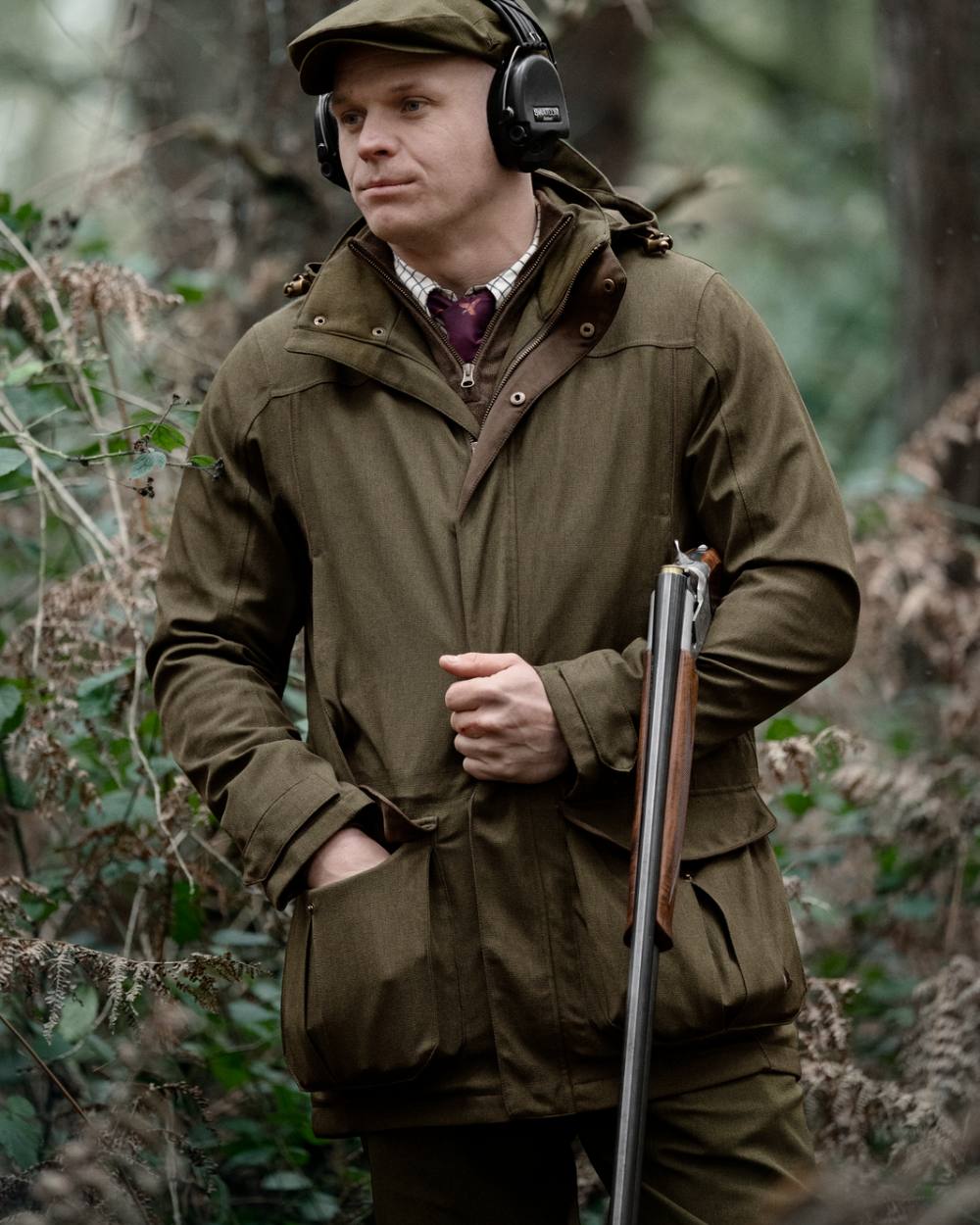 Shaded Olive coloured Seeland Mens Woodcock Royale Jacket on forest background