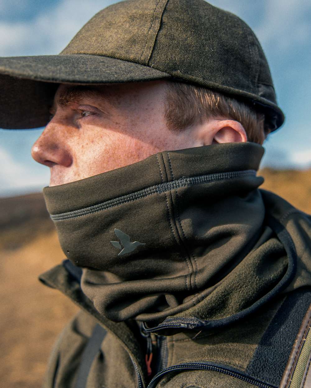 Pine Green Coloured Seeland Neck Gaiter on outdoor background