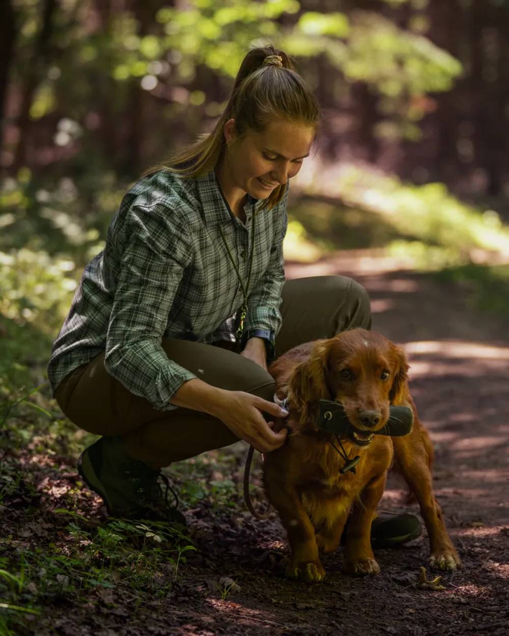 Pine Green coloured Seeland Womens Larch Stretch Trousers on forest background