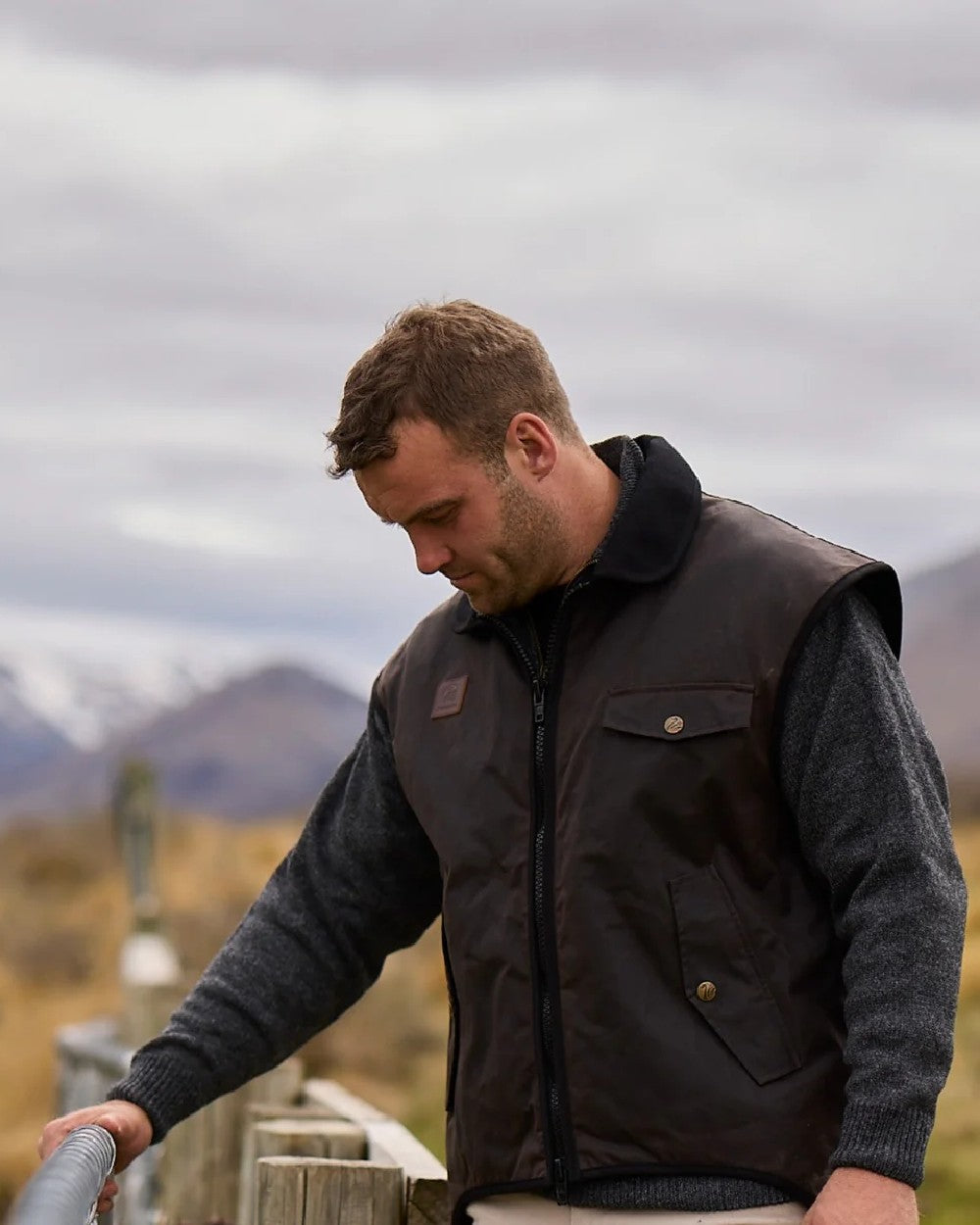 Brown Coloured Swanndri Mens Foxton Oilskin Vest with Wool Lining on sky background