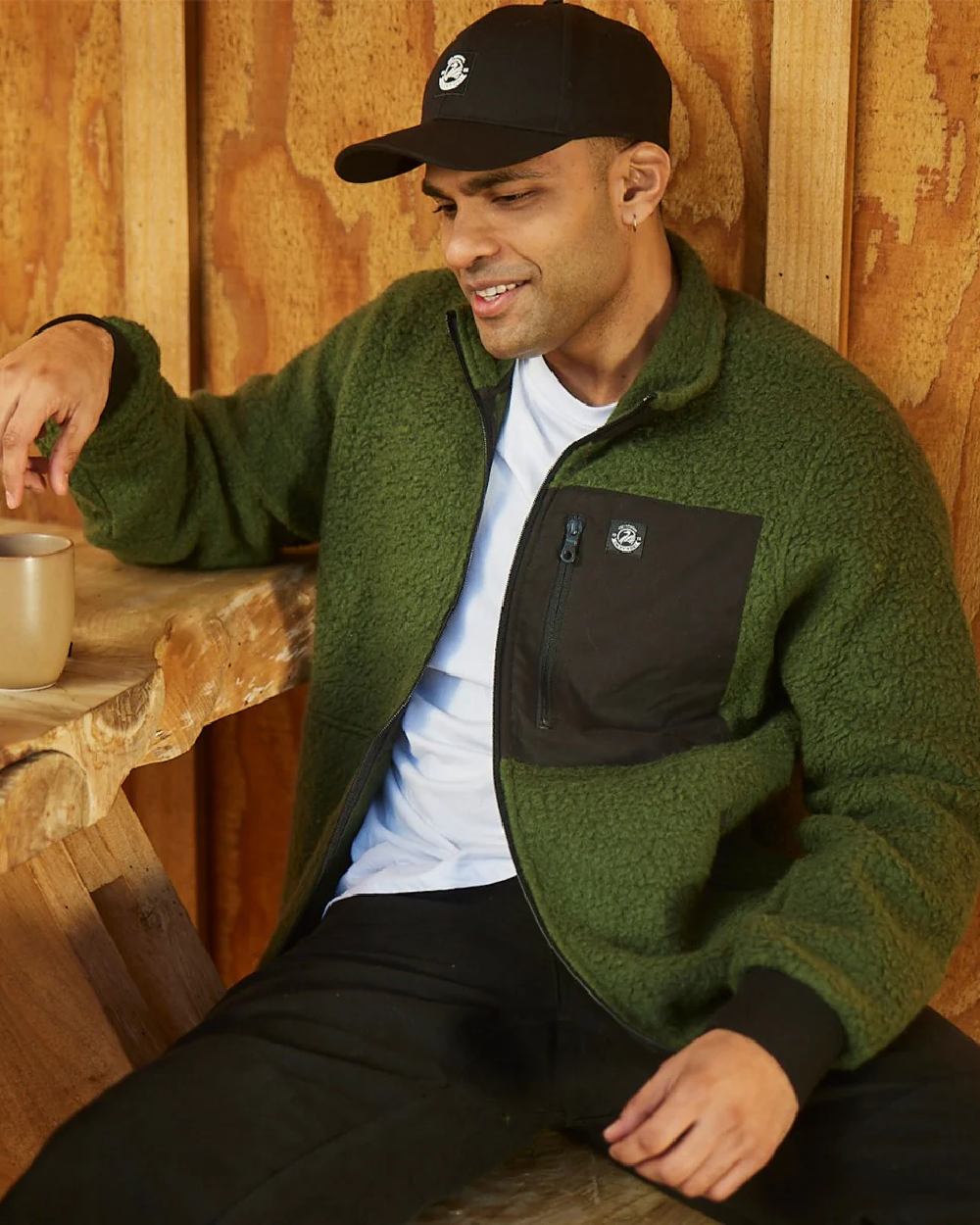 Black Coloured Swanndri Swanni Baseball Cap on cafe background