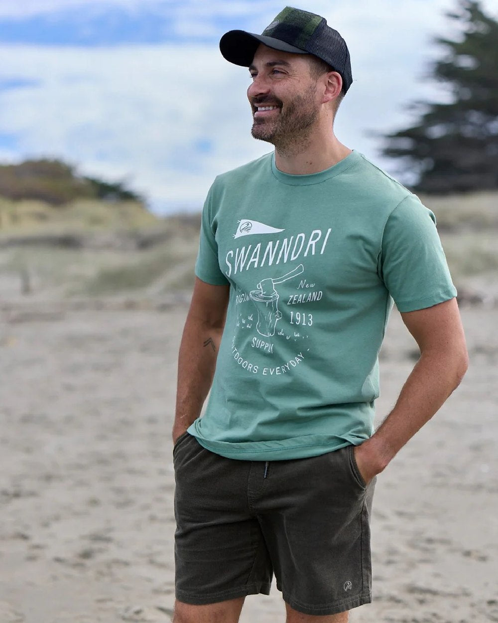 Olive Black Check Coloured Swanndri Swanni Trucker Cap on coastal background