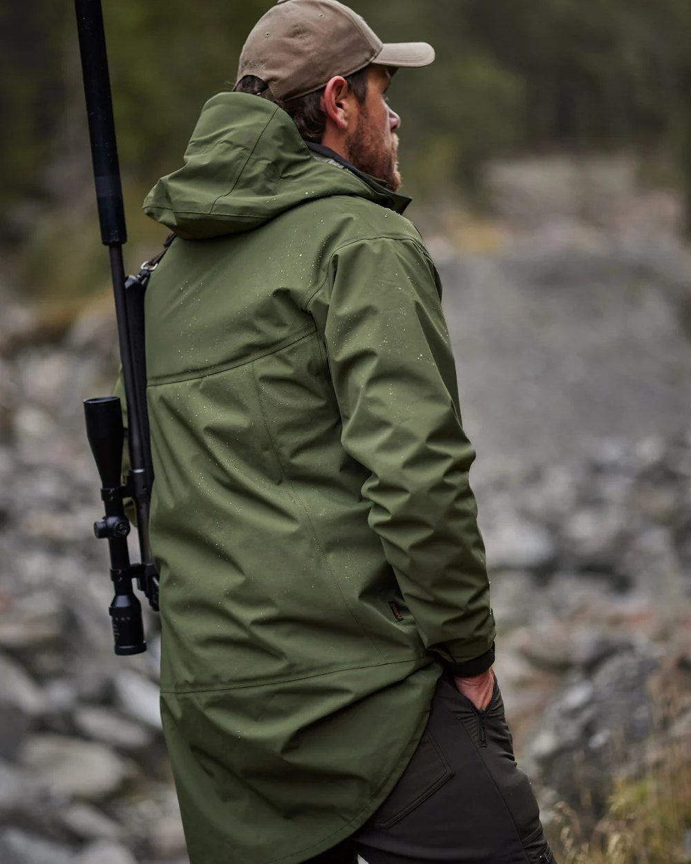 Olive coloured Swazi Mens Sentinel Ultralight Jacket on rock background