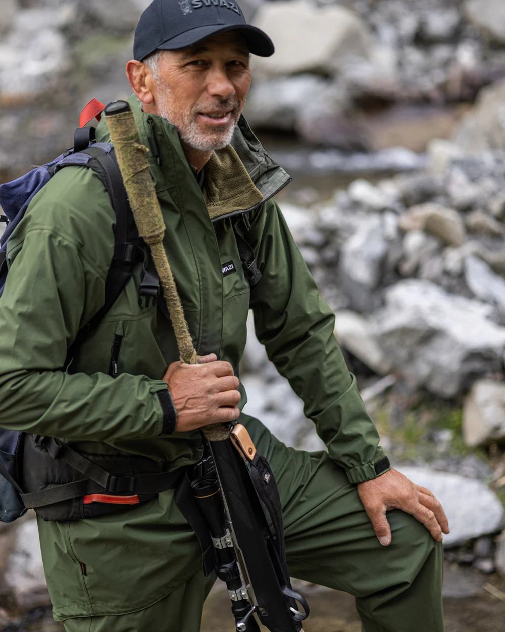 Olive coloured Mens Swazi Mens Tahr Ultralite Jacket on rock background