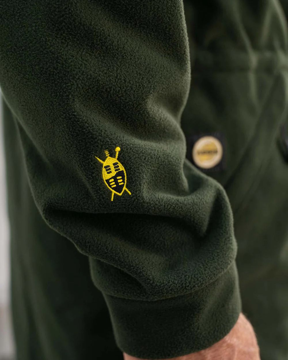Olive coloured Swazi Mens Windriver Jacket on floor background