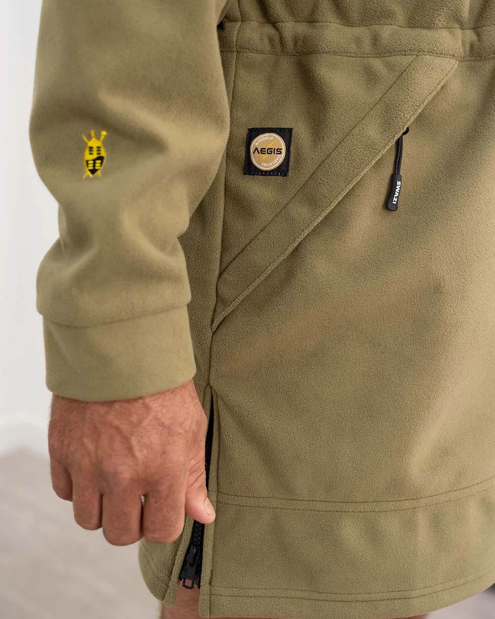 Tussock coloured Swazi Mens Windriver Jacket on floor background