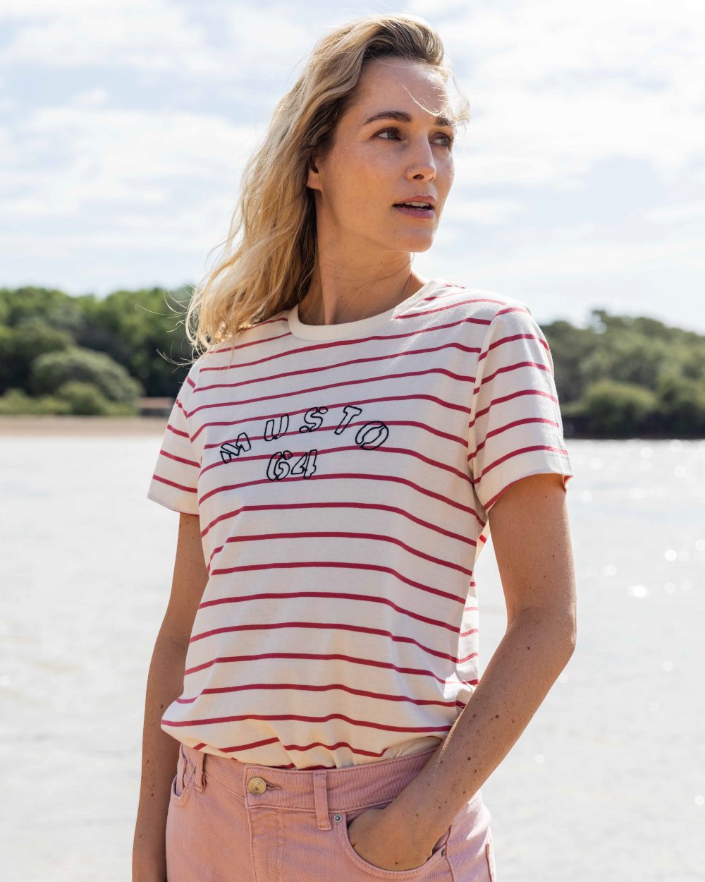 Sweet Raspberry/ASW Coloured Musto Womens Classic Striped Short Sleeve T-Shirt On A Beach Background