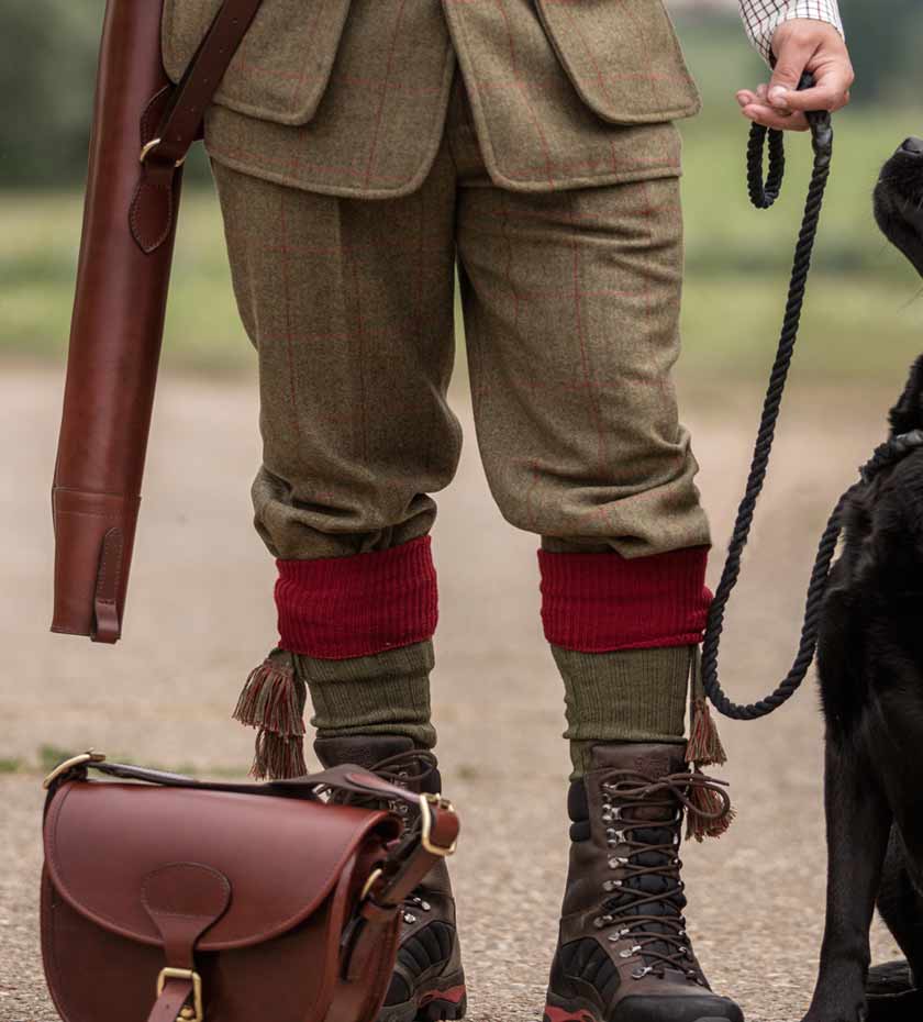 Man wearing Alan Paine Tweed shooting breeks with hunting boots and shooting socks.