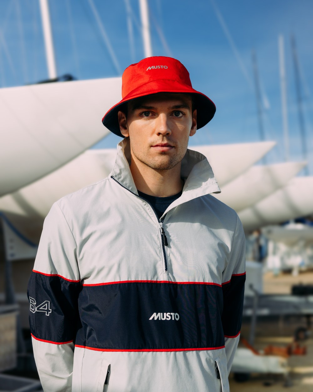 True Red/Navy Musto Salcombe Reversible Bucket Hat On A Boat Background