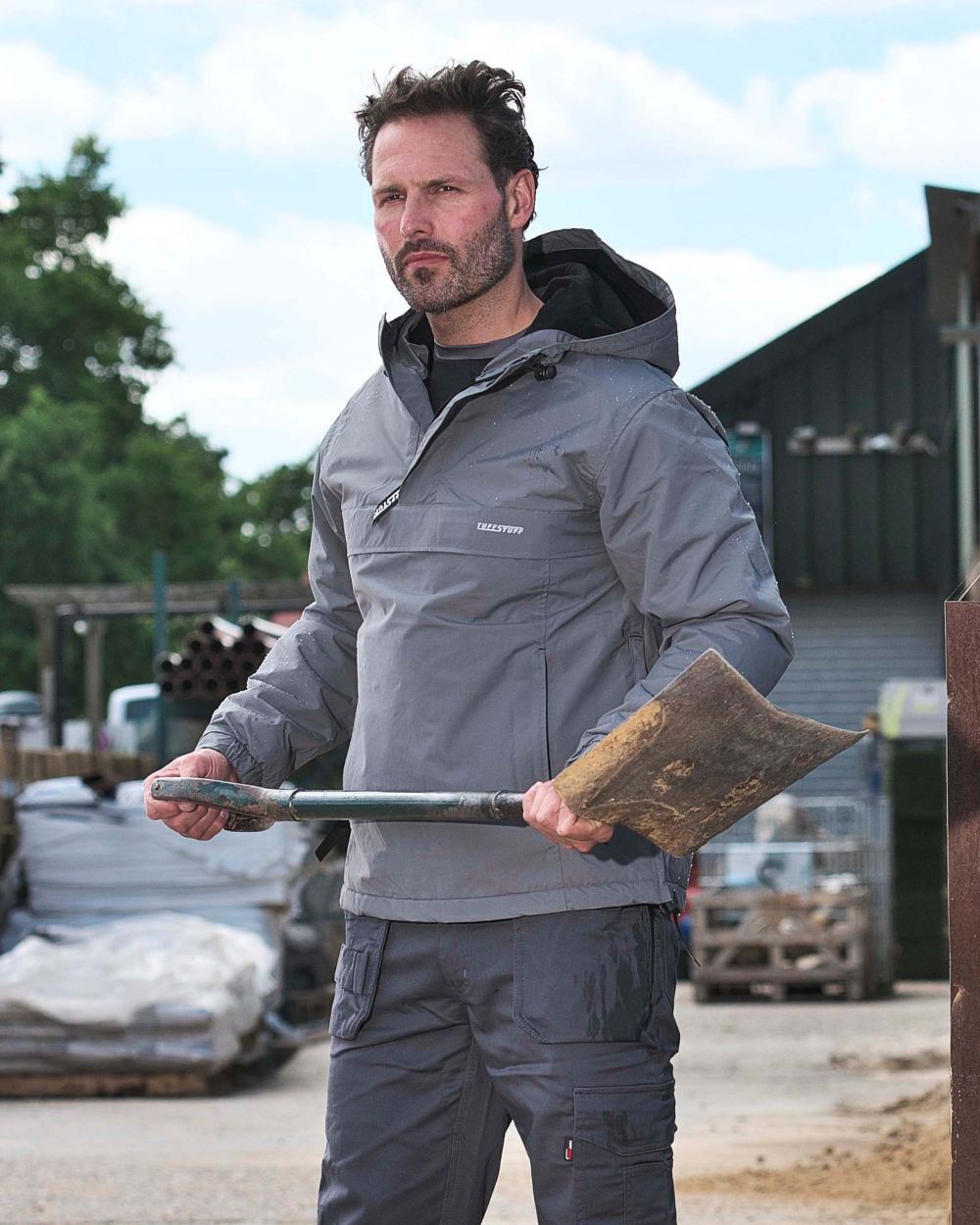 Grey Coloured TuffStuff Sutherland Waterproof Windbreaker Smock On A Factory Background