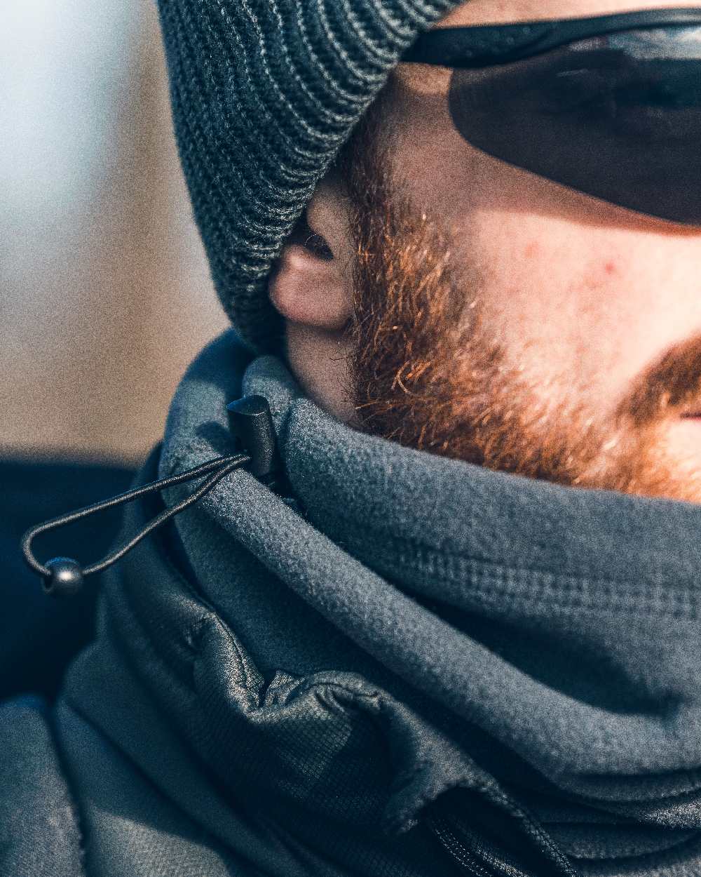 Titanium Coloured Viper Tactical Neck Gaiter on blurry background
