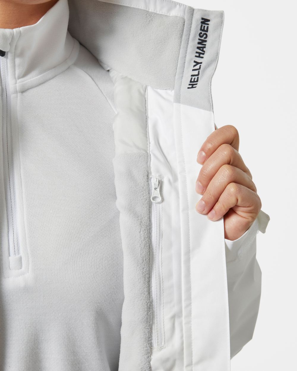 White coloured Helly Hansen Womens Crew Midlayer Sailing Jacket 2.0 on grey background