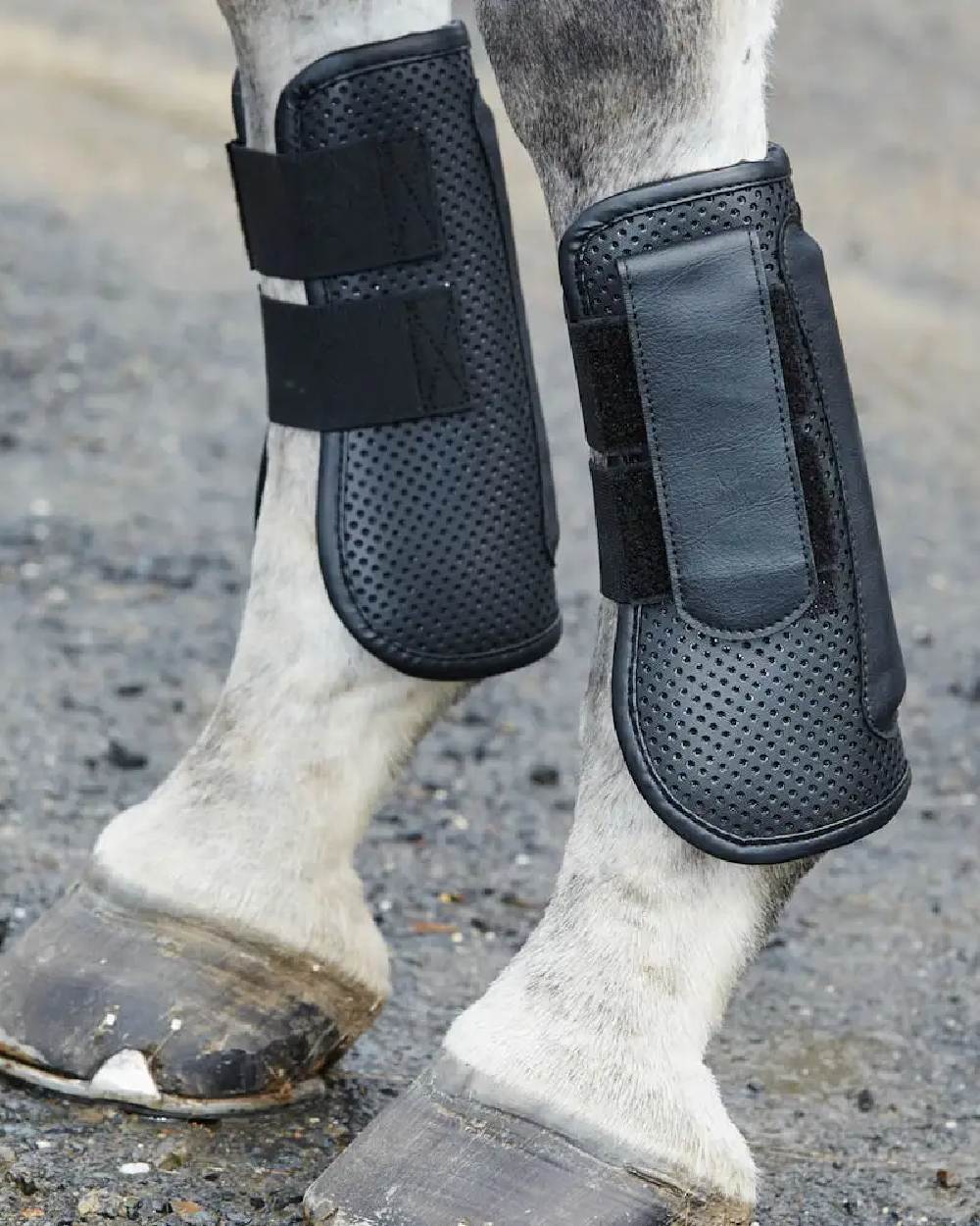 Black coloured WeatherBeeta Lite Open Front Boots on blurry background