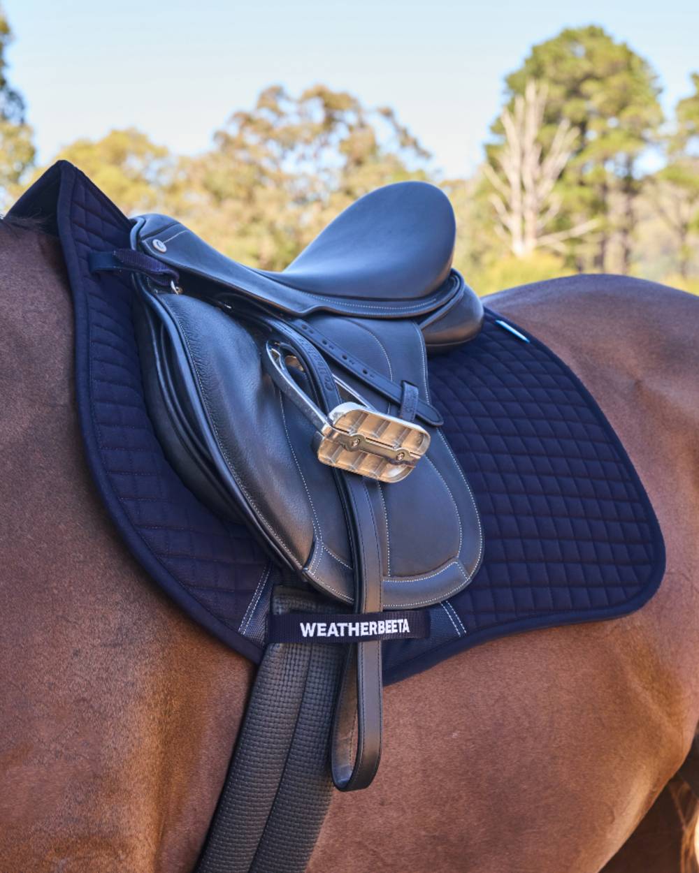 Navy Coloured WeatherBeeta Prime Air-Tec All Purpose Saddle Pad on horse background