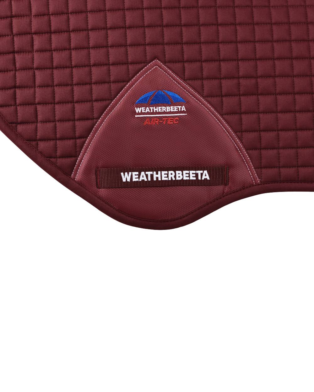 Burgundy Coloured WeatherBeeta Prime Air-Tec Jump Shaped Saddle Pad on white background