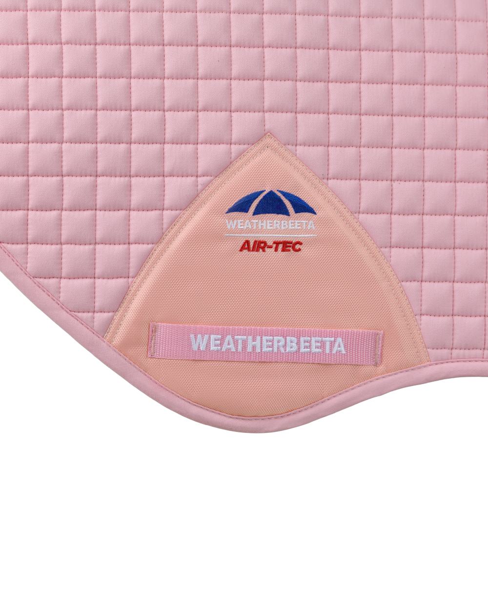 Light Pink Coloured WeatherBeeta Prime Air-Tec Jump Shaped Saddle Pad on white background