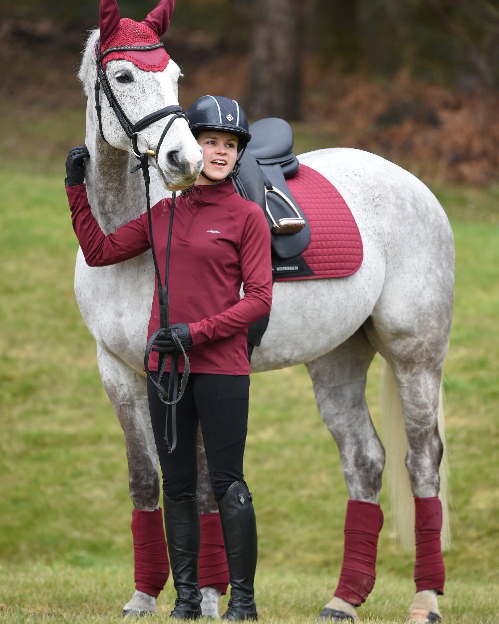 Maroon coloured WeatherBeeta Prime Long Sleeve Top on green background