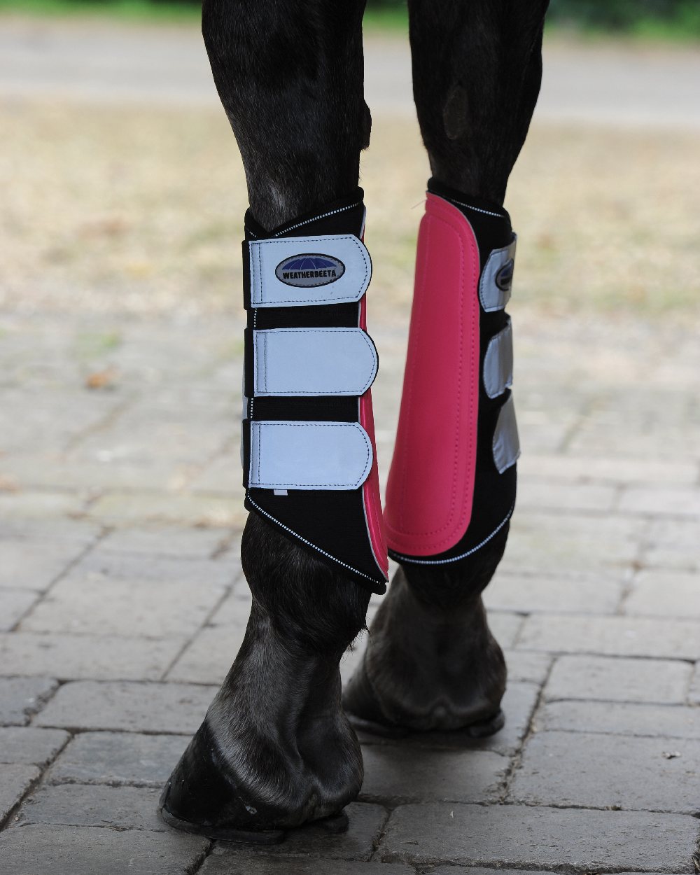 Pink Silver coloured WeatherBeeta Reflective Single Lock Brushing Boots on blurry background