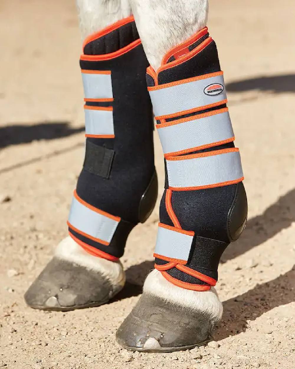 Black Silver Red coloured WeatherBeeta Therapy-Tec Stable Boot Wraps on track background