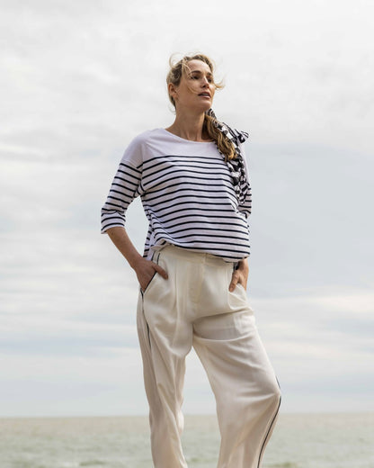 White/Navy Coloured Musto Womens Falmouth Striped T-Shirt On A Beach Background 