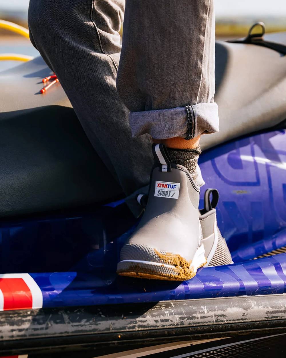 Grey Coloured Xtratuf Mens 6" Ankle Deck Sport Boots on outdoor background