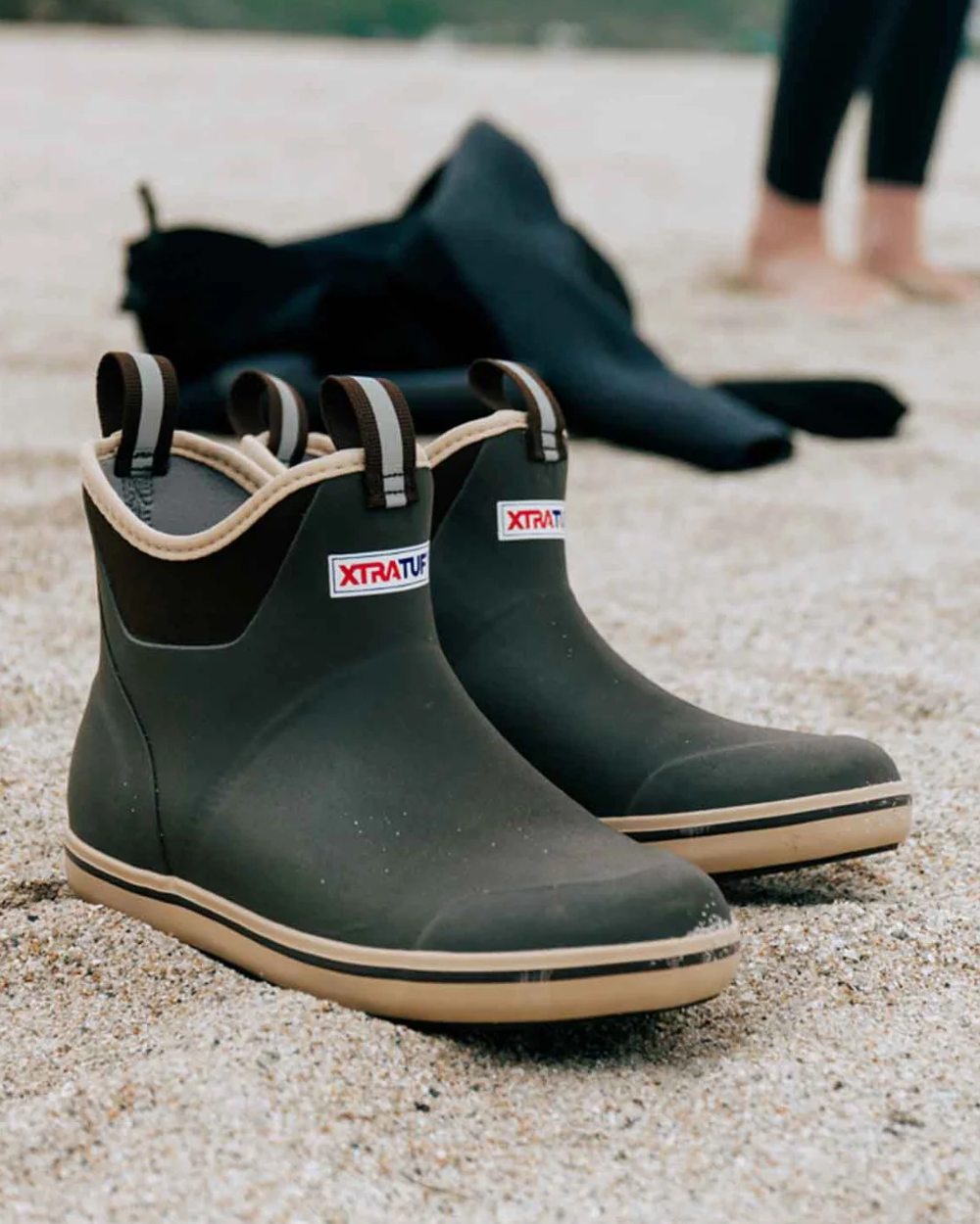 Brown coloured Xtratuf Womens 6" Ankle Deck Boots on outdoor background