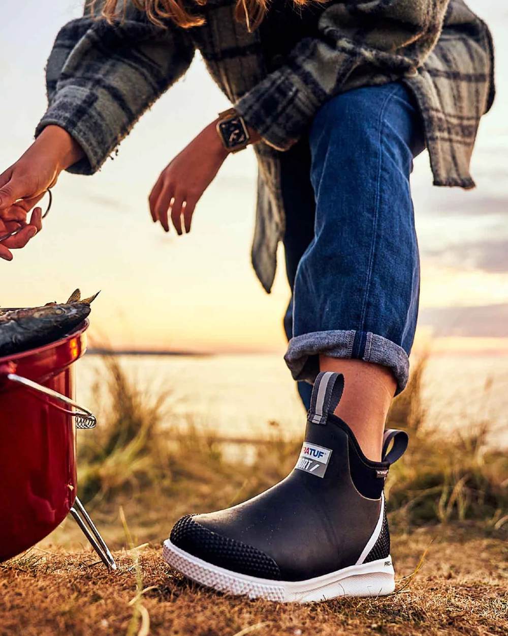 Black Coloured Xtratuf Womens 6" Ankle Deck Sport Boots on outdoor background