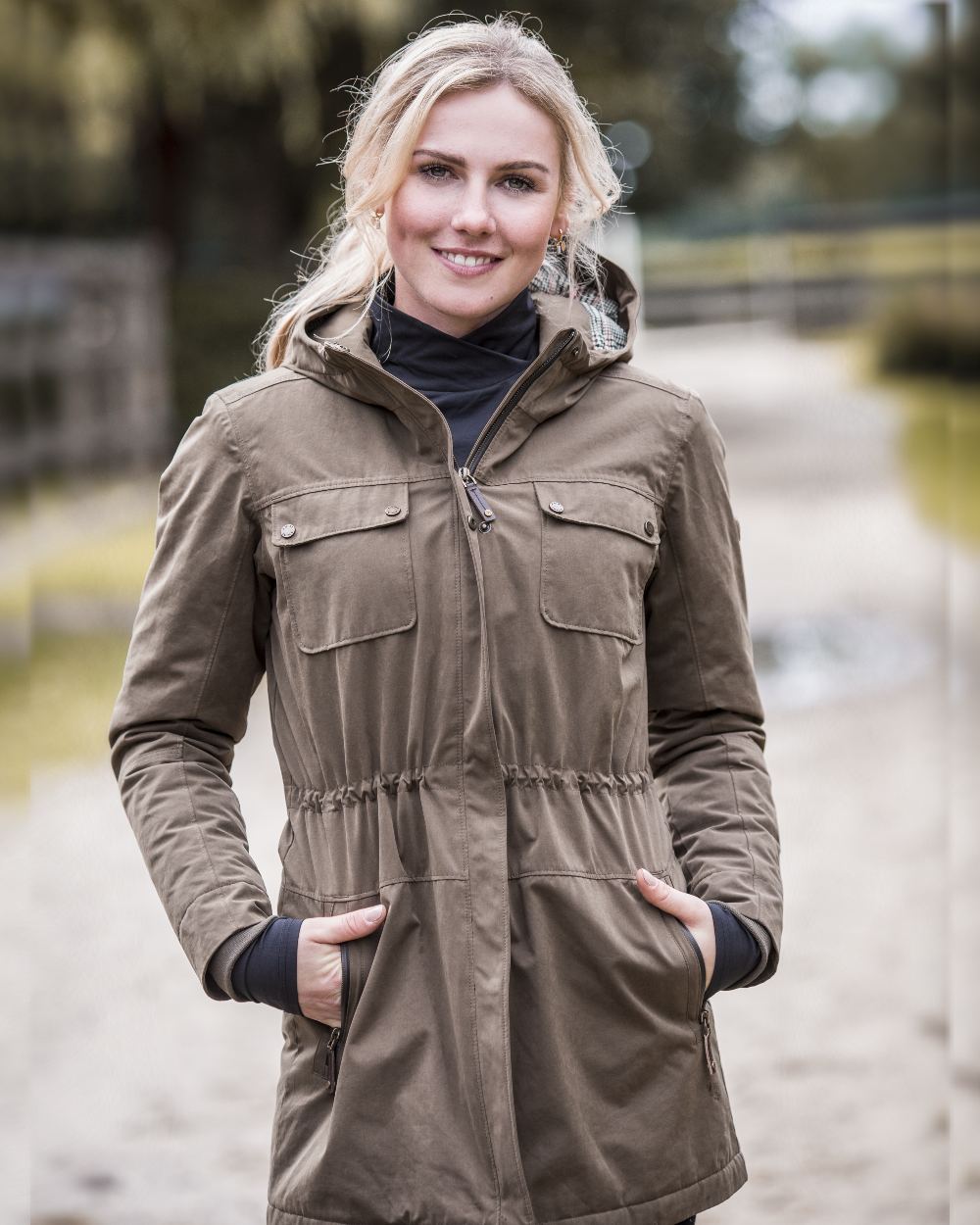 Earth Coloured Ariat Womens Argentium Waterproof Parka On A Blurry Background