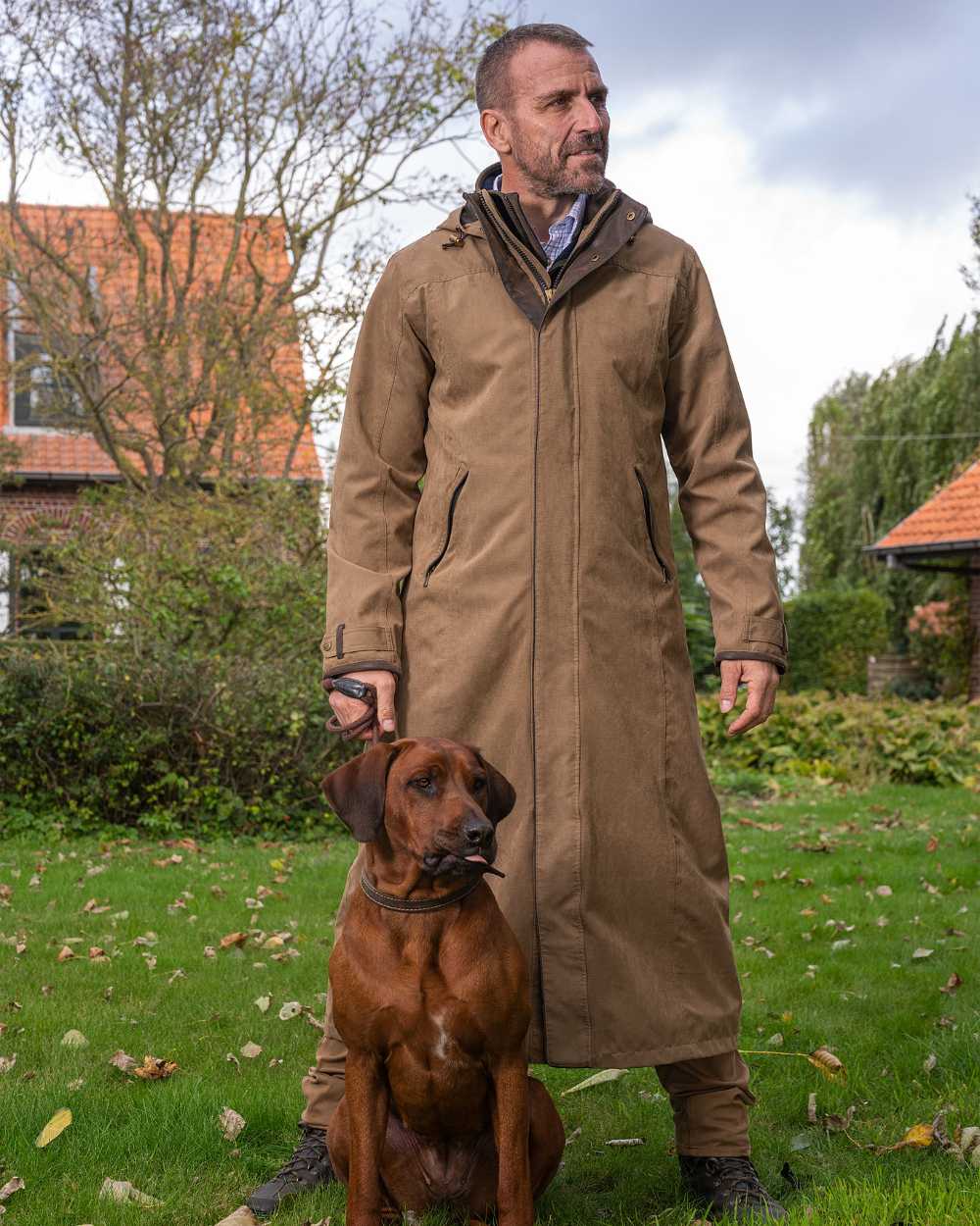 Camel Coloured Baleno Livingstone Long Waterproof Coat On A Backyard Background