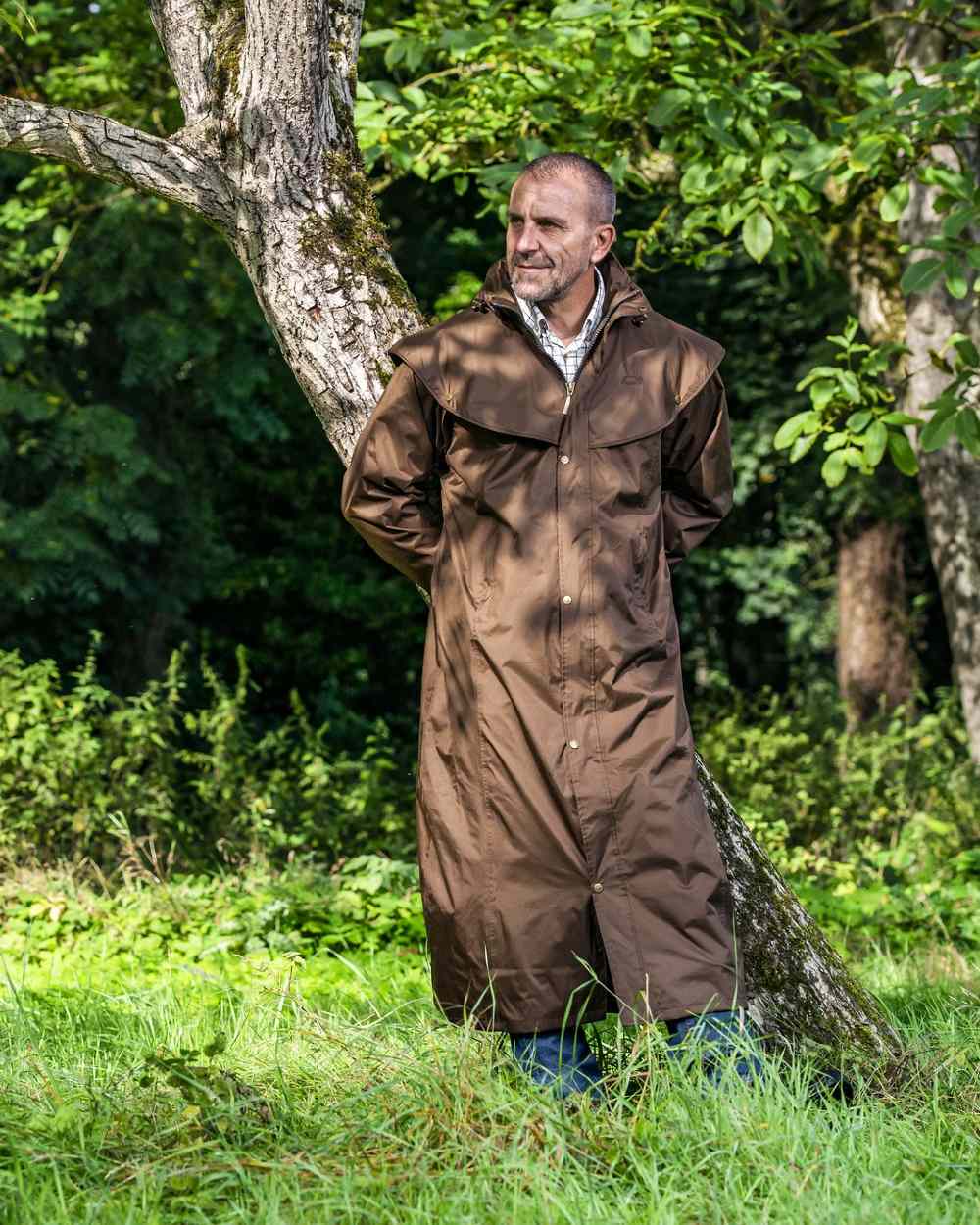 Brown Coloured Baleno Newbury Waterproof Long Coat On A Forest Background