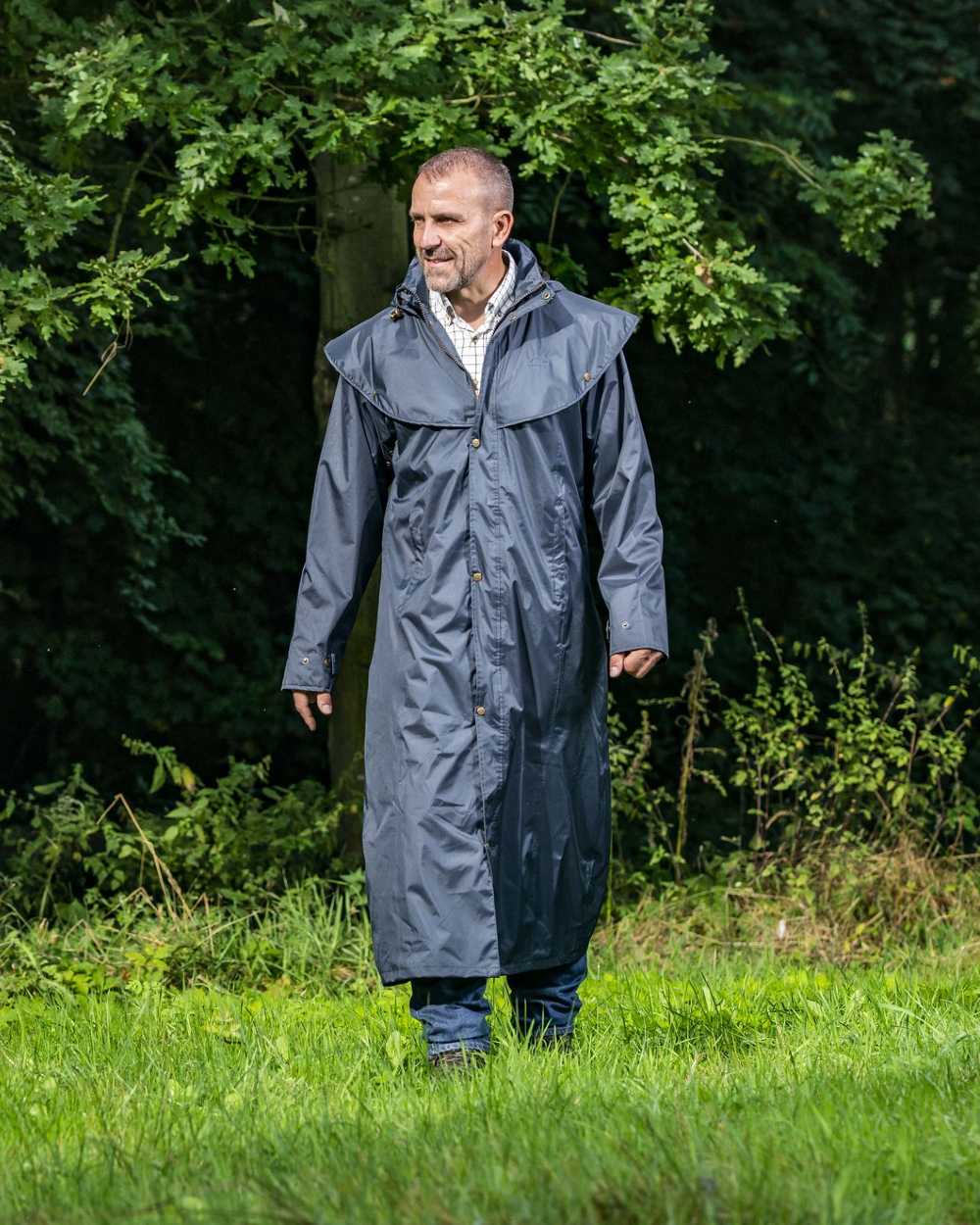 Navy Blue Coloured Baleno Newbury Waterproof Long Coat On A Forest Background