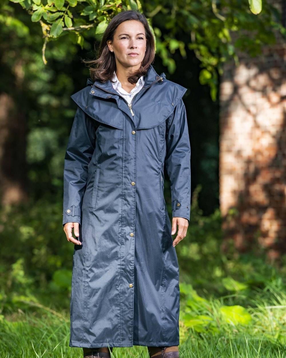 Navy Coloured Baleno Oxford Long Waterproof Coat On A Backyard Background