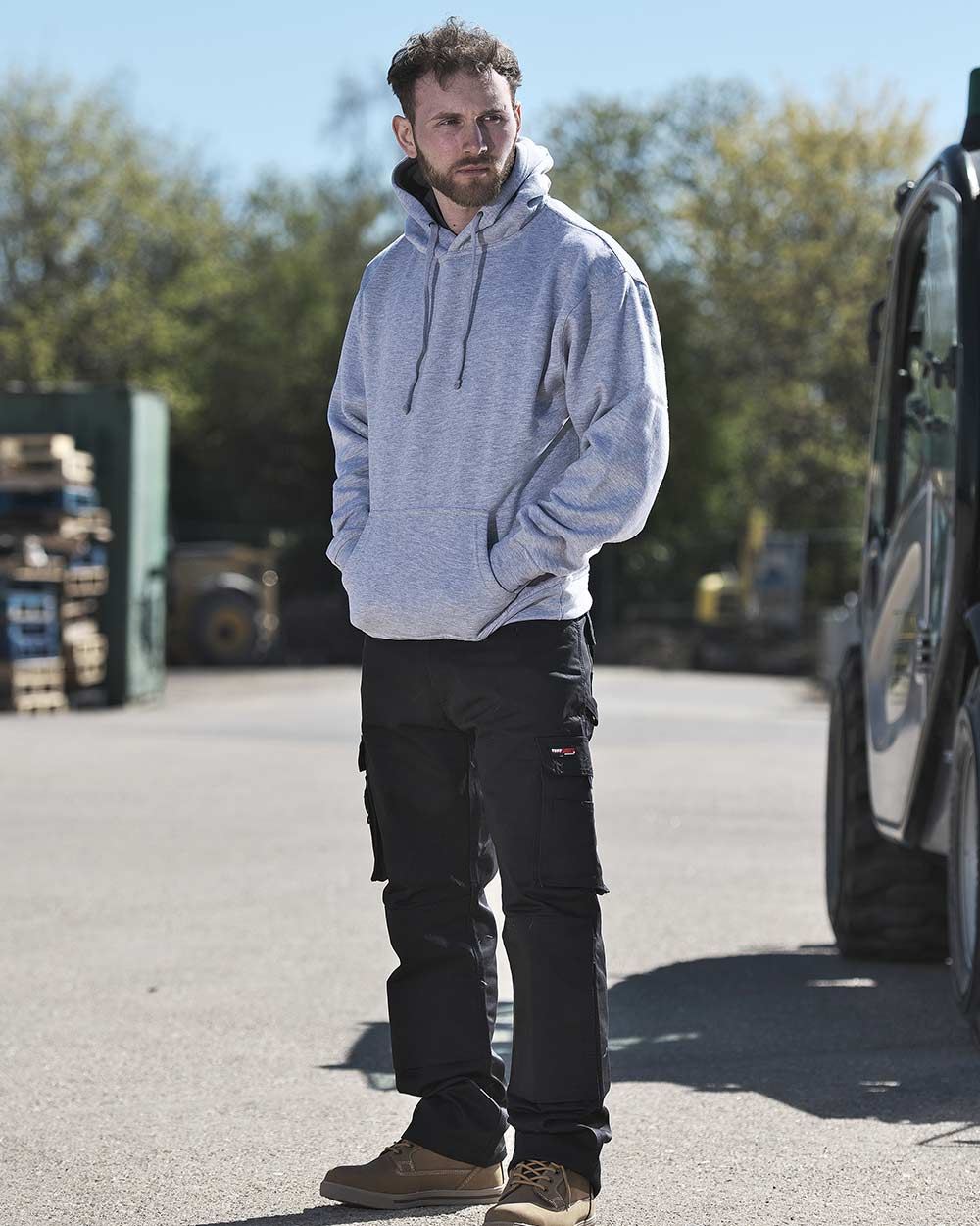 Black Coloured TuffStuff Pro Work Trousers On A Street Background