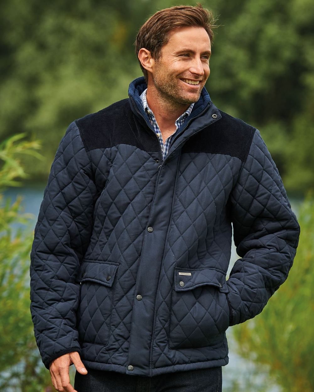 Navy Coloured Champion Lewis Diamond Quilted Jacket On A Lake Background