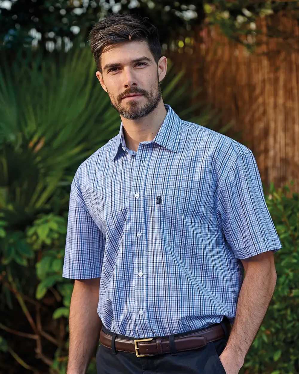 Blue Coloured Champion Poole Short Sleeve Shirt On A Garden Background
