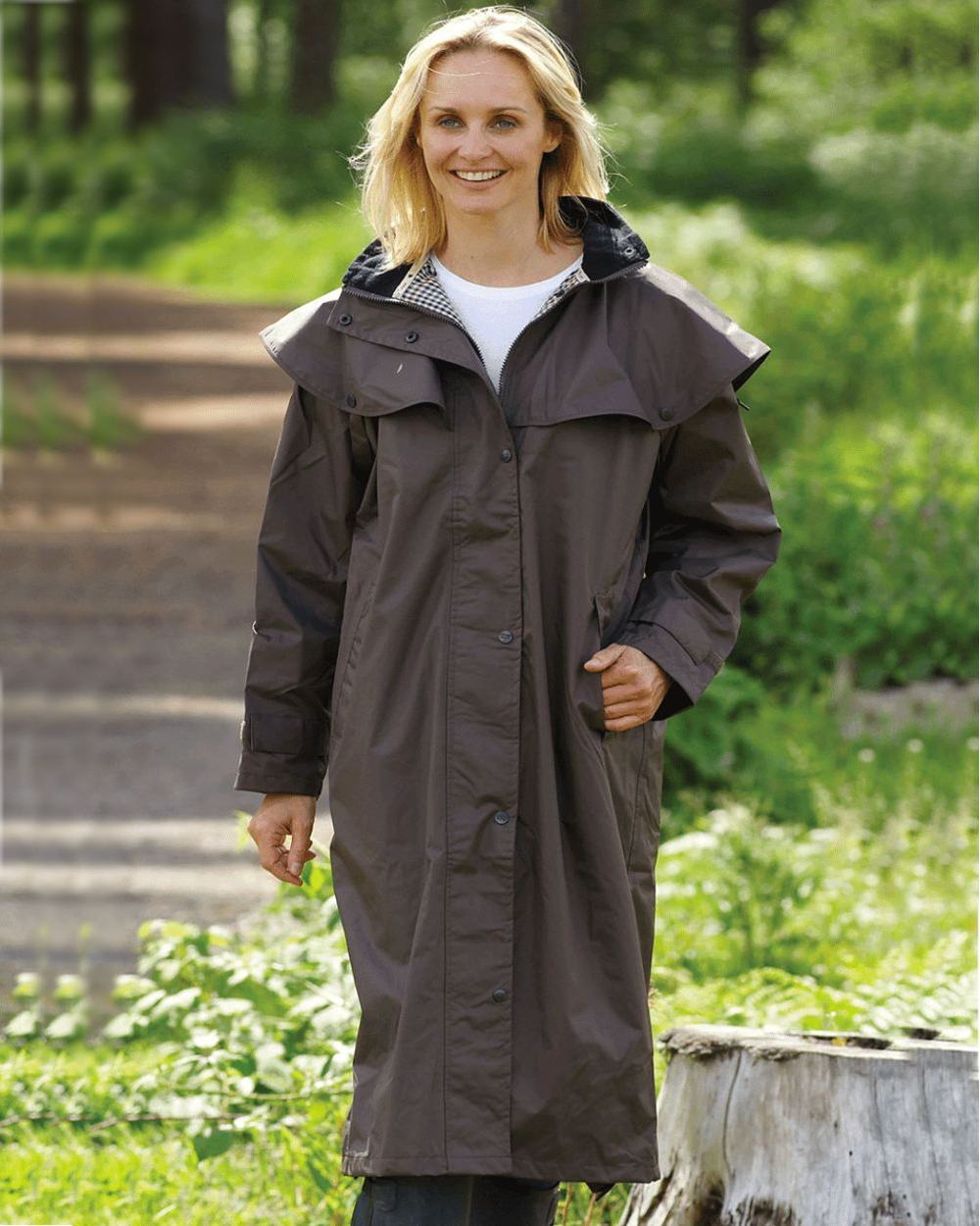 Brown Coloured Champion Sandringham Long Waterproof Coat On A Forest Background